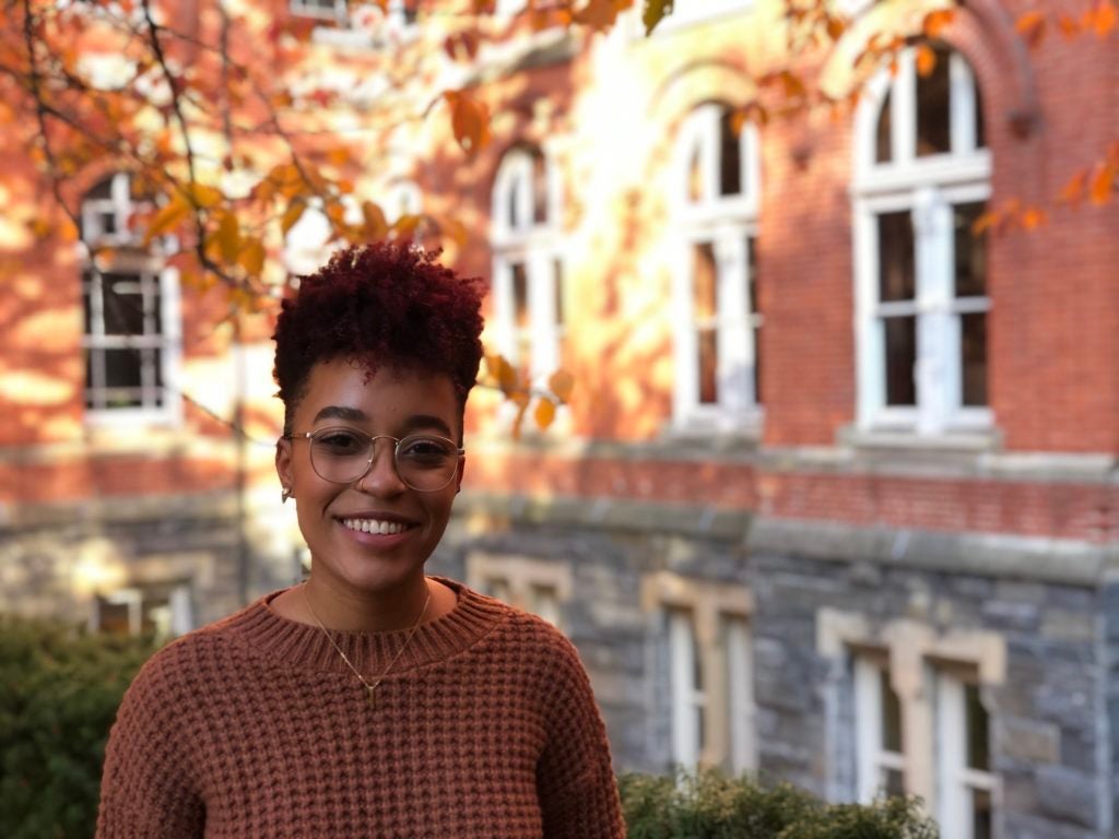 Senior nursing major Morgan Robinson (NHS’20) poses by Healy Hall with autumn leaves