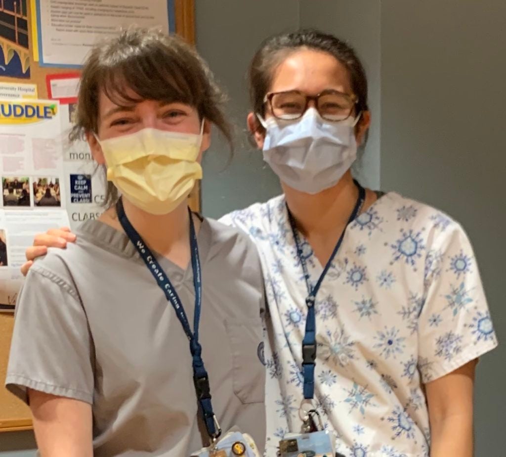 Moira Redmond (NHS’17) and Catherine Zolbrod Freeman (NHS’17) stand in clinical attire and masks