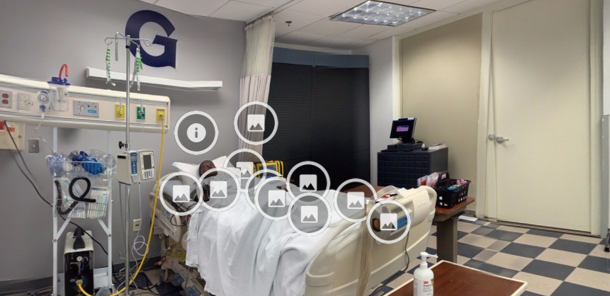 A screenshot from the web-based virtual simulation scenario shows a patient simulator in a hospital bed.