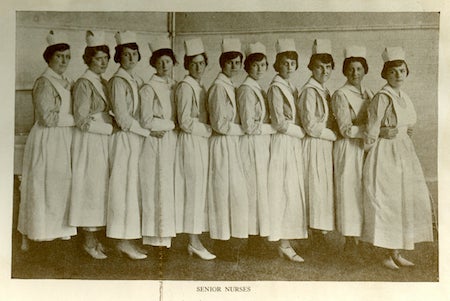 An image of the senior nursing class in their student nursing uniforms in a line from the 1920 Ye Domesday Booke yearbook.