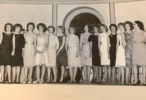 A group of Georgetown nursing students in formal attire in the late 1950s or early 1960s at a singing performance