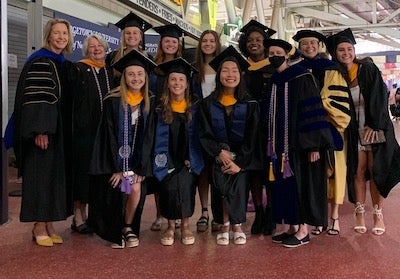 A group photo at Georgetown's Commencement at Nationals Park with individuals in academic gowns