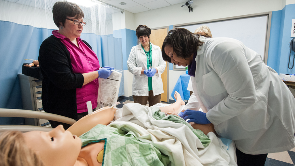 Students participate in a midwifery simulation