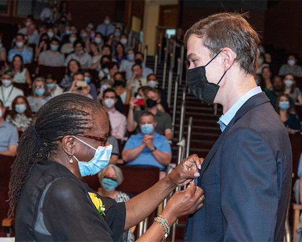 Edilma L. Yearwood pins Alexander Brown (G’22).