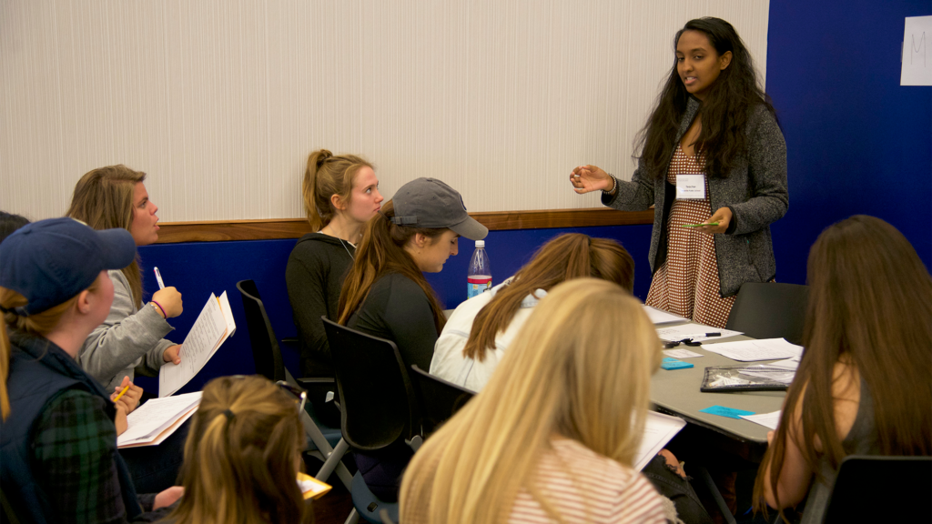 A nursing student speaks before a group of other students