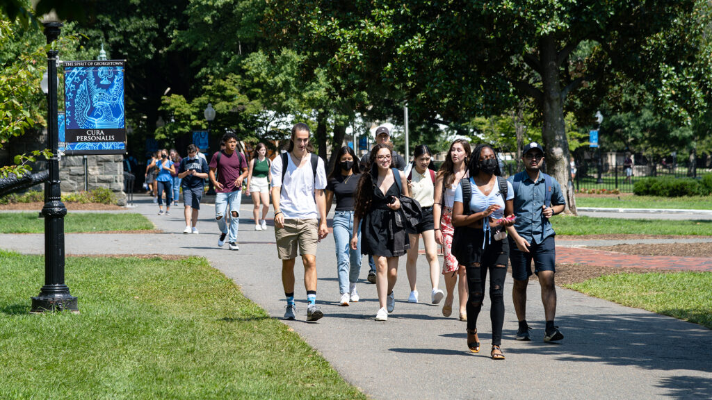 Students walk along a path on campus 
