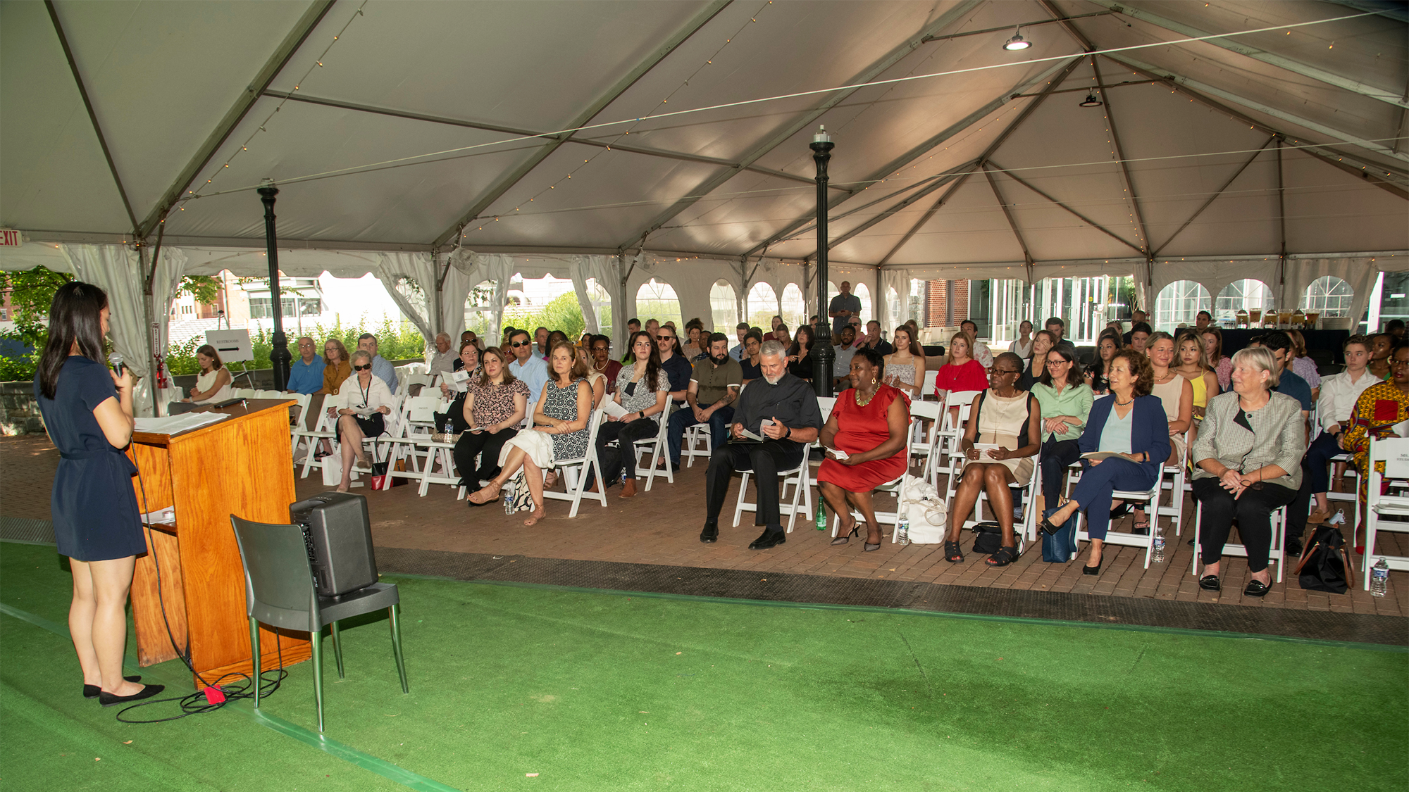 A view of the crowd attending the Nursing White Coat ceremony in a large tent outdoors