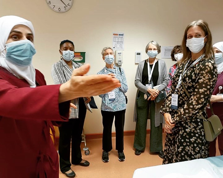 Nurses provide a tour to a group of visiting nurse midwives