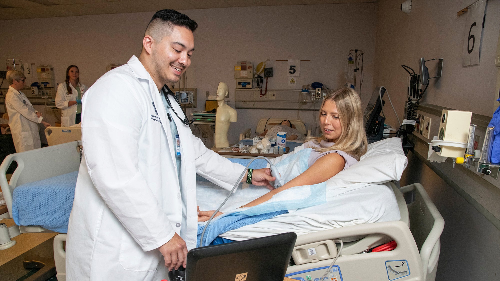 A student nurse performs an ultrasound on a mock patient