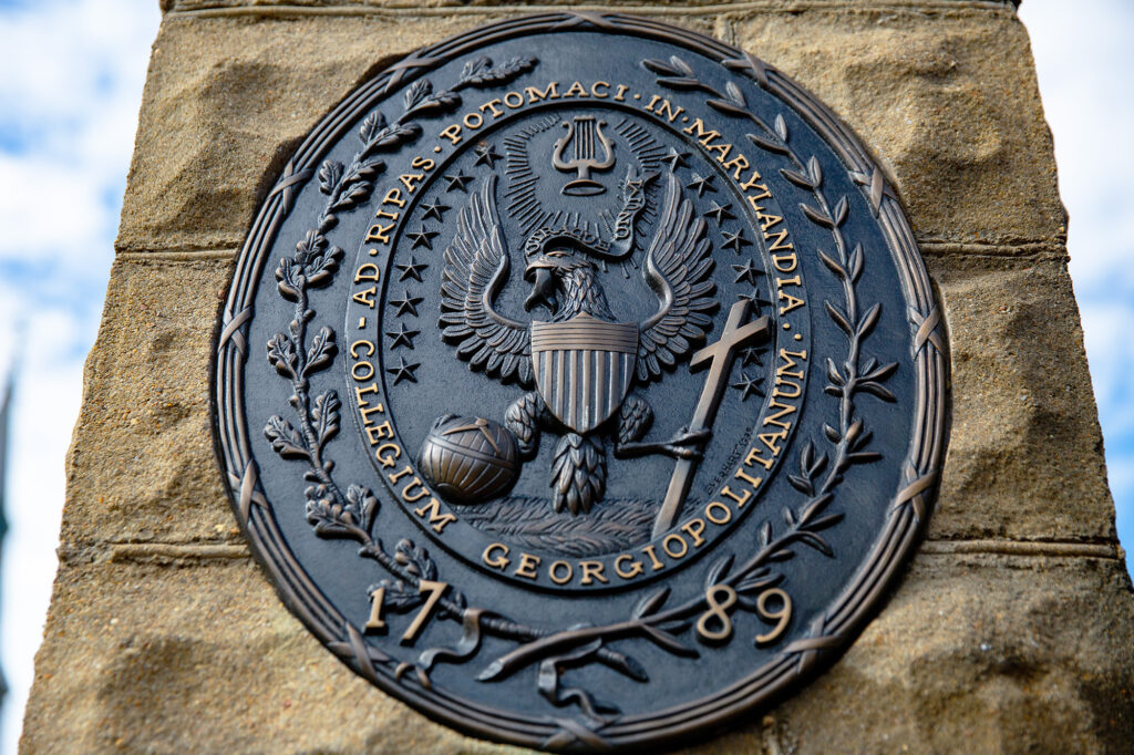 Georgetown University seal in bronze on a brick pillar