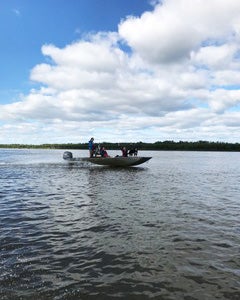 A boat skims the surface of the ocean