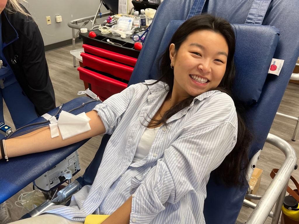 Volunteer smiling while donating blood at the Oct 20 blood drive.