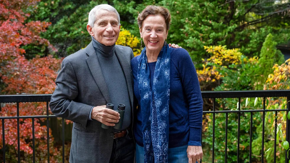 Anthony Fauci and Christine Grady stand together outdoors