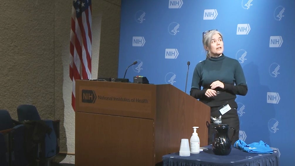 Dr. Mirabel Beltran speaks at a podium at the NIH