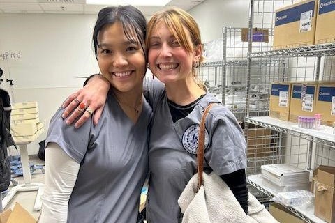 Two nursing students stand together