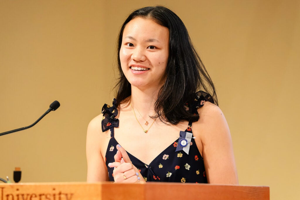 Maggie Kim speaks at a podium