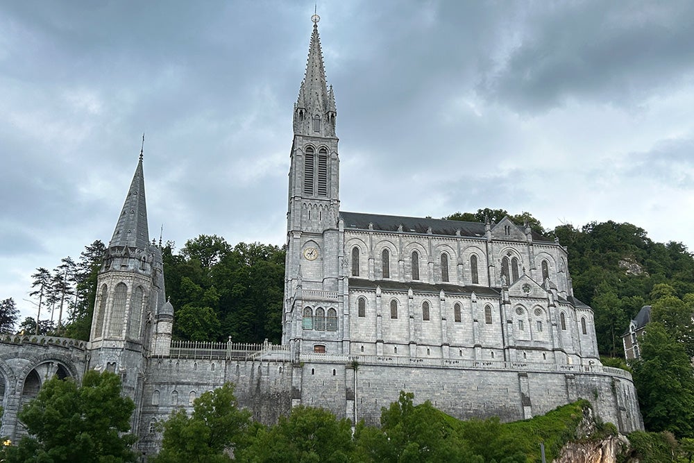 The cathedral at Lourdes rises above the river