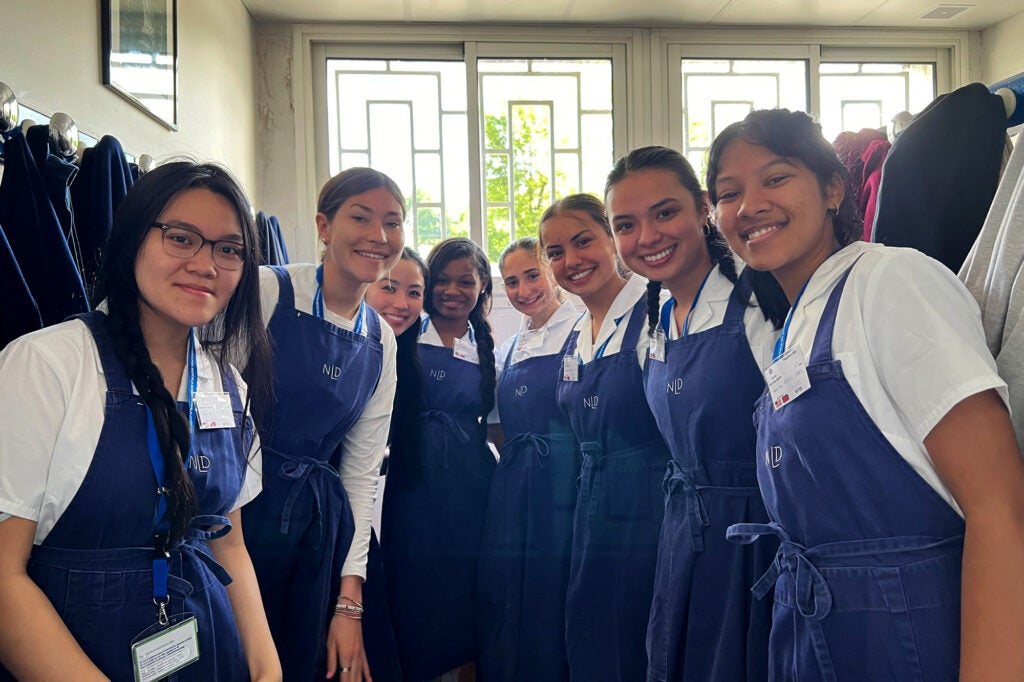 Students stand side by side as they prepare to volunteer in the baths