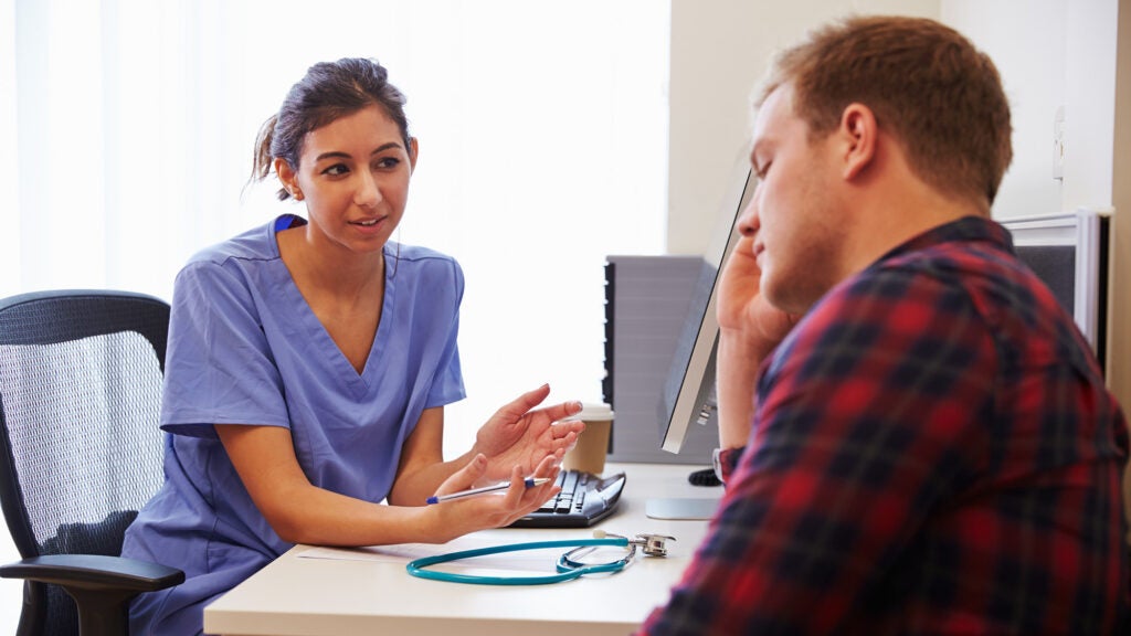 A nurse counsels a person in distress