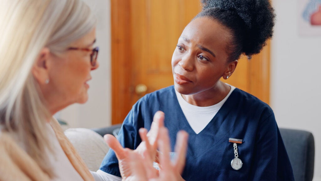 A nurse listens as a patient speaks