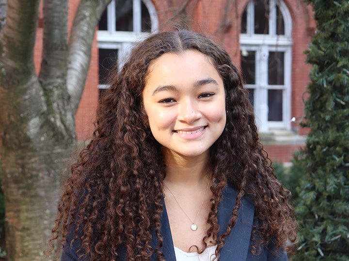 Sydney Blackston smiling outside of campus building