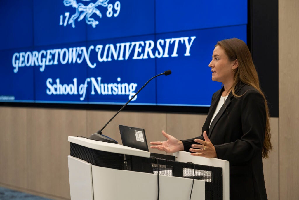 Margaret Brassinga stands at a podium to present her project.