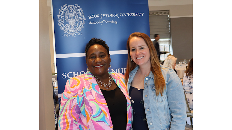 Dean Waite standing next to Lindsay McDonnell in front of a Georgetown University School of Nursing sign.