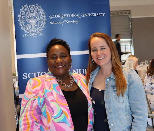 Dean Waite standing next to Lindsay McDonnell in front of a Georgetown University School of Nursing sign.
