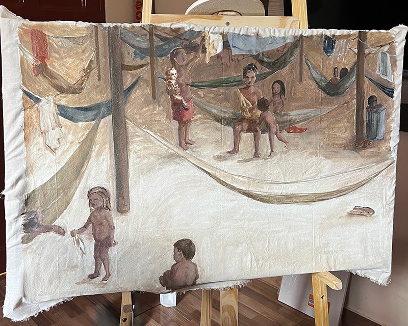 A canvas on a easel displays the start of an oil painting depicting indigenous women and children interacting among hammocks