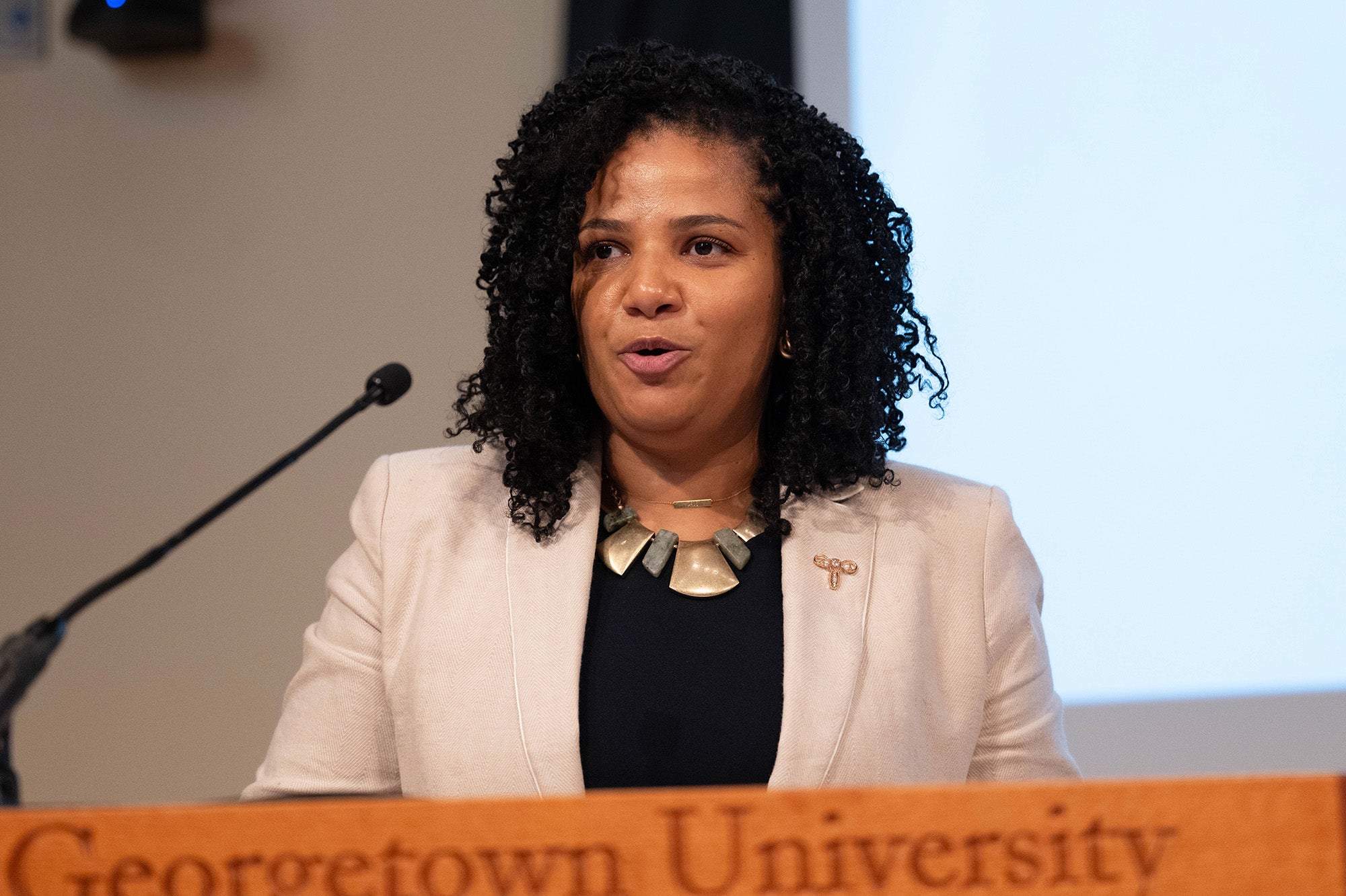 Jessica Wells speaks from a podium