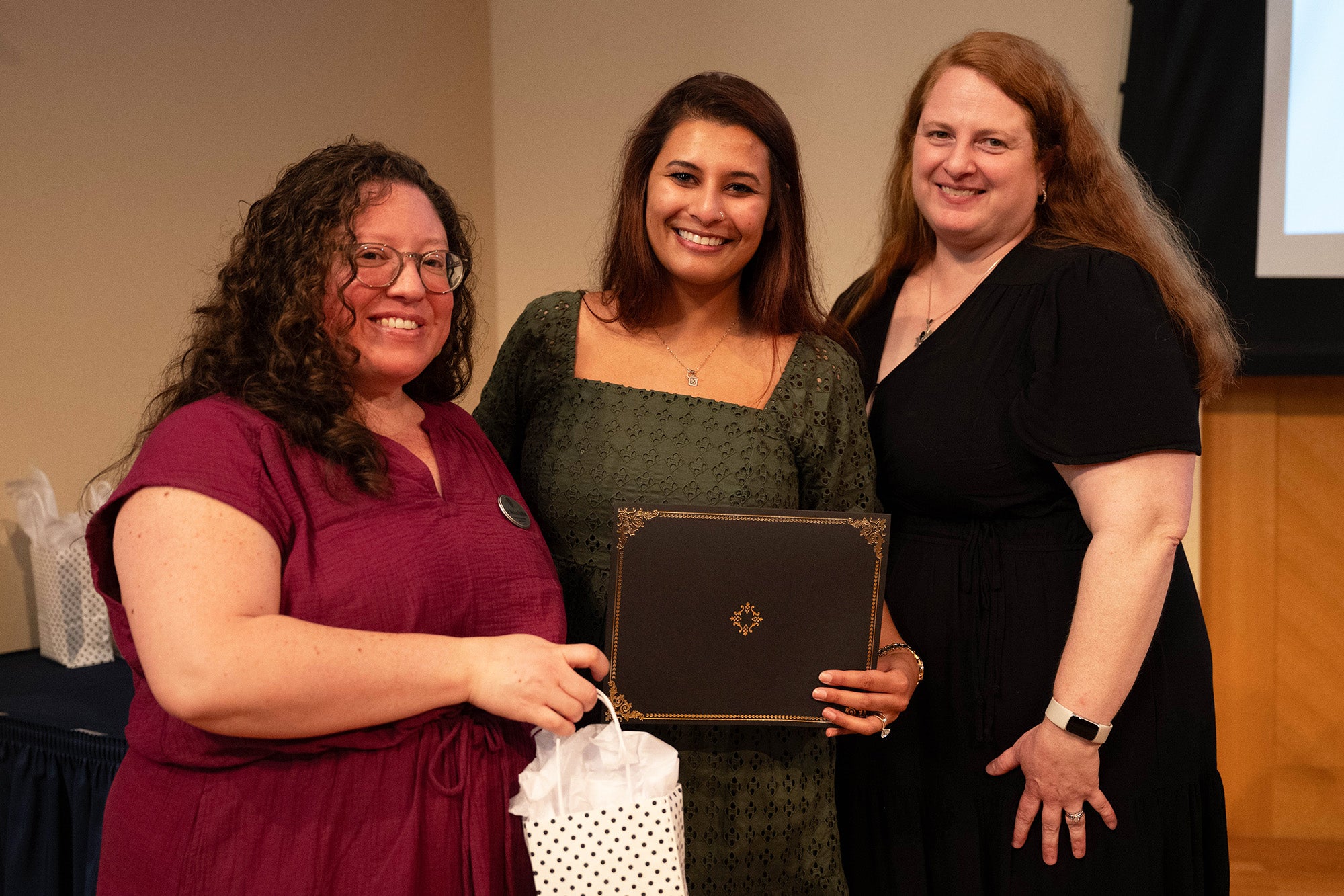 Melicia Escobar, Janet Reid, and Ella Heitzler stand together