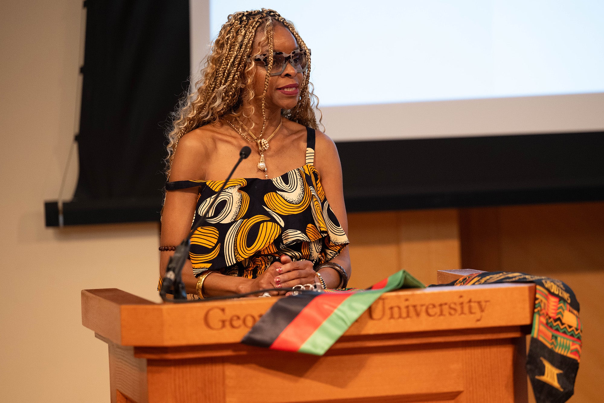 Masimbiti Kunje speaks from a podium