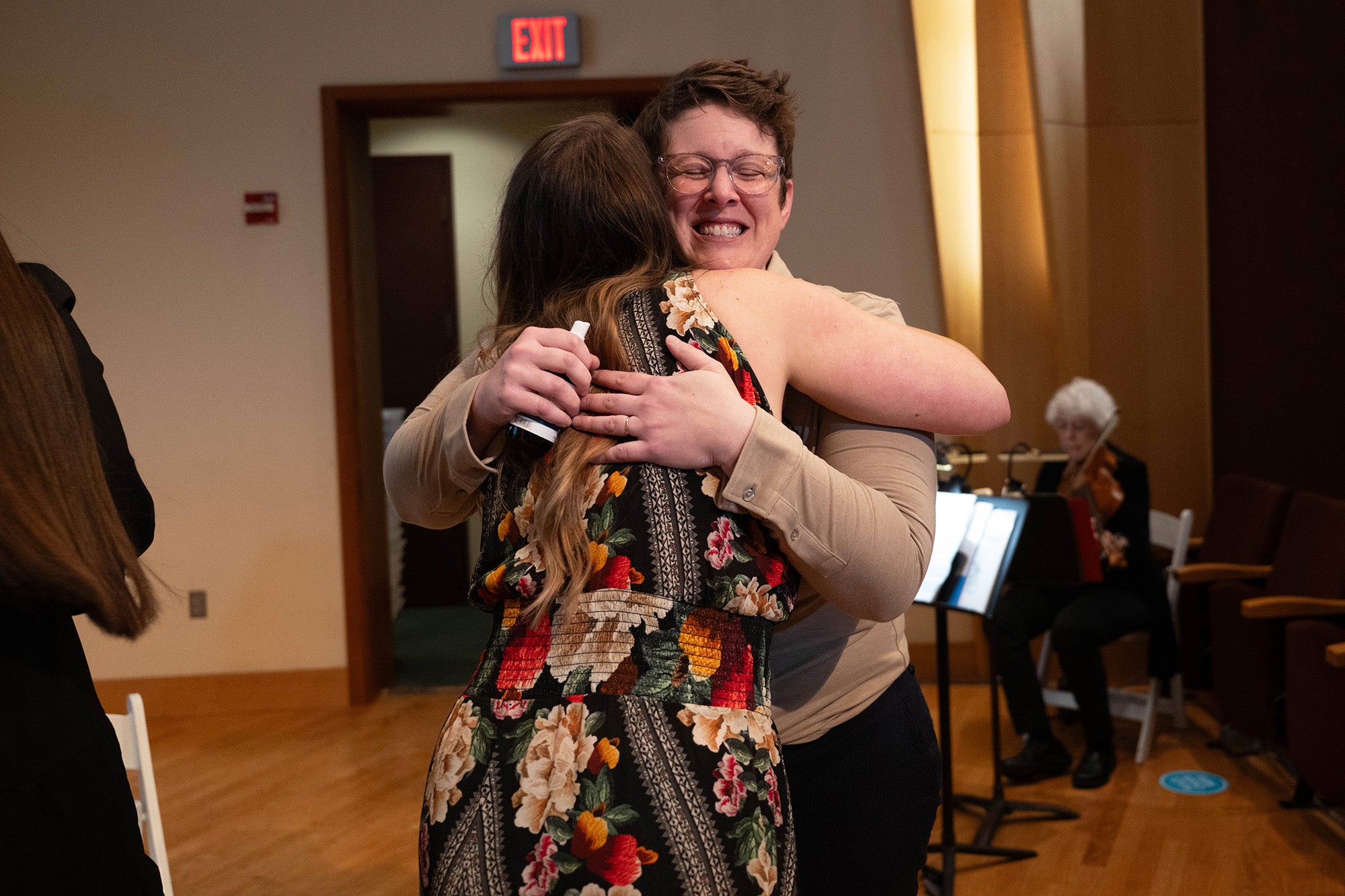 Katie DePalma hugs a student during the ceremony