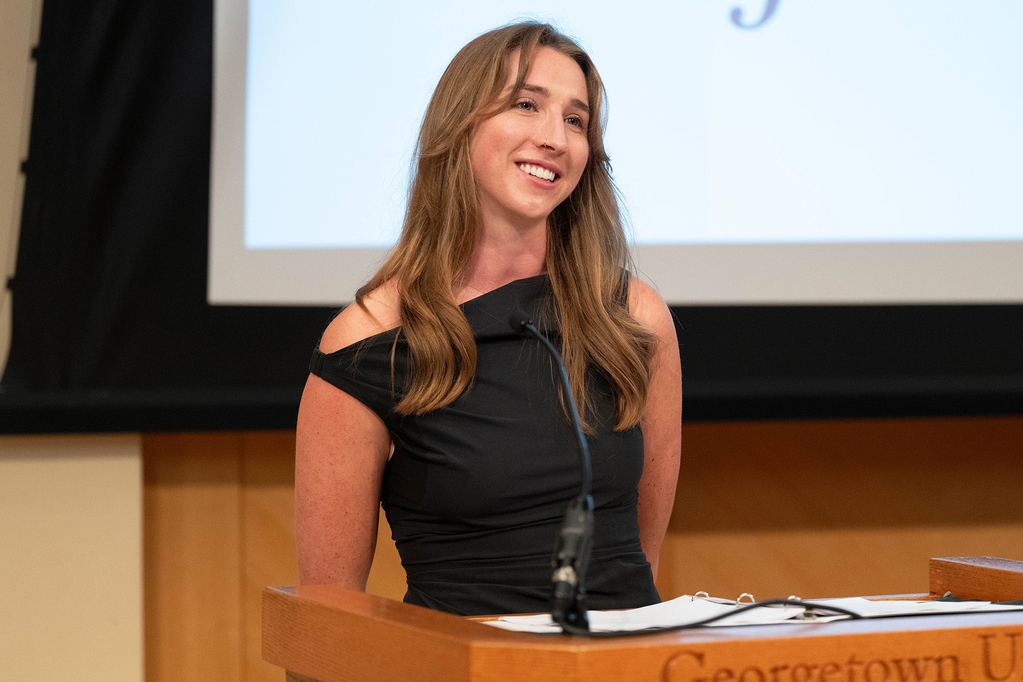 Sara Kate Besanceney speaks from a podium