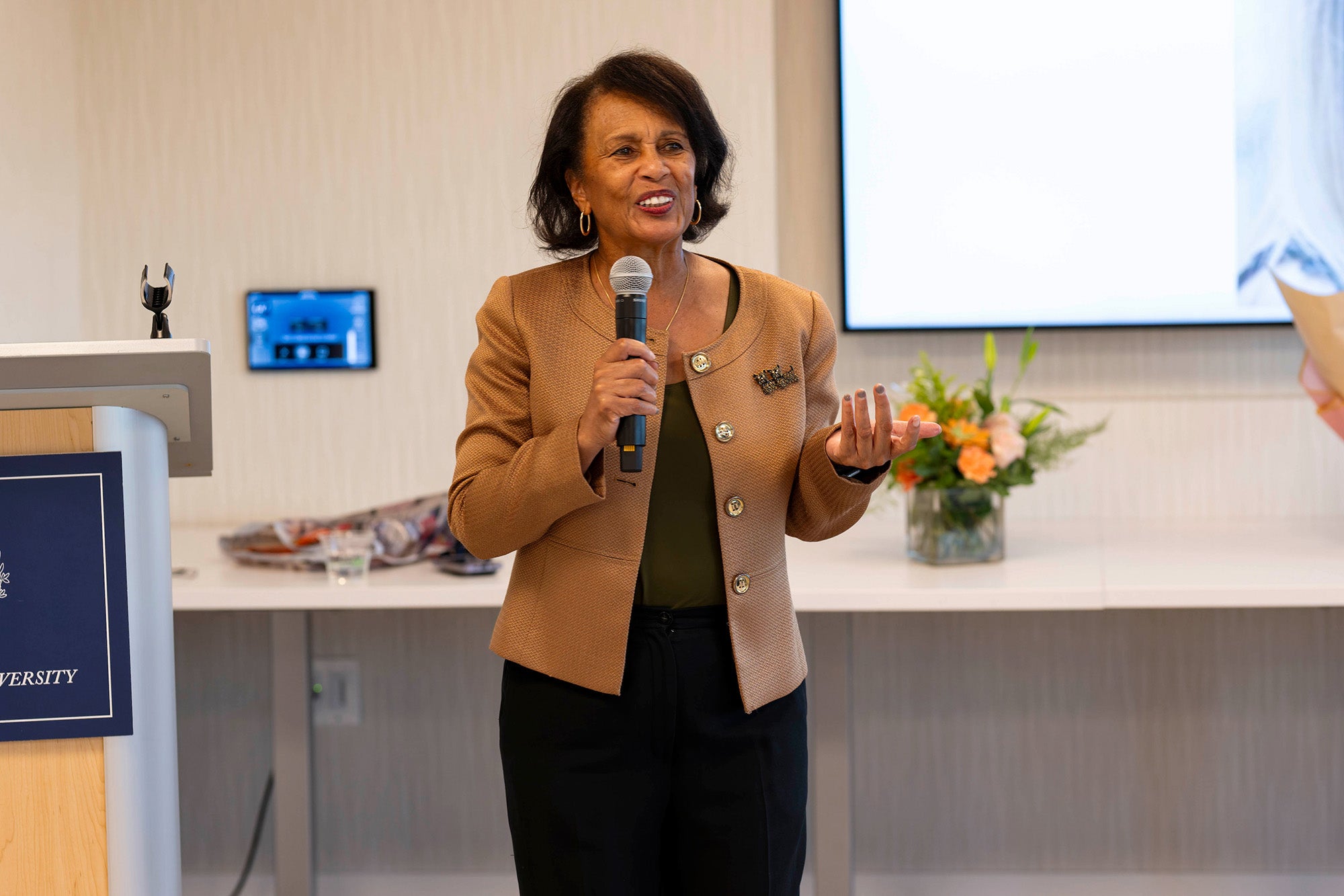 Beverly Malone speaks into a microphone