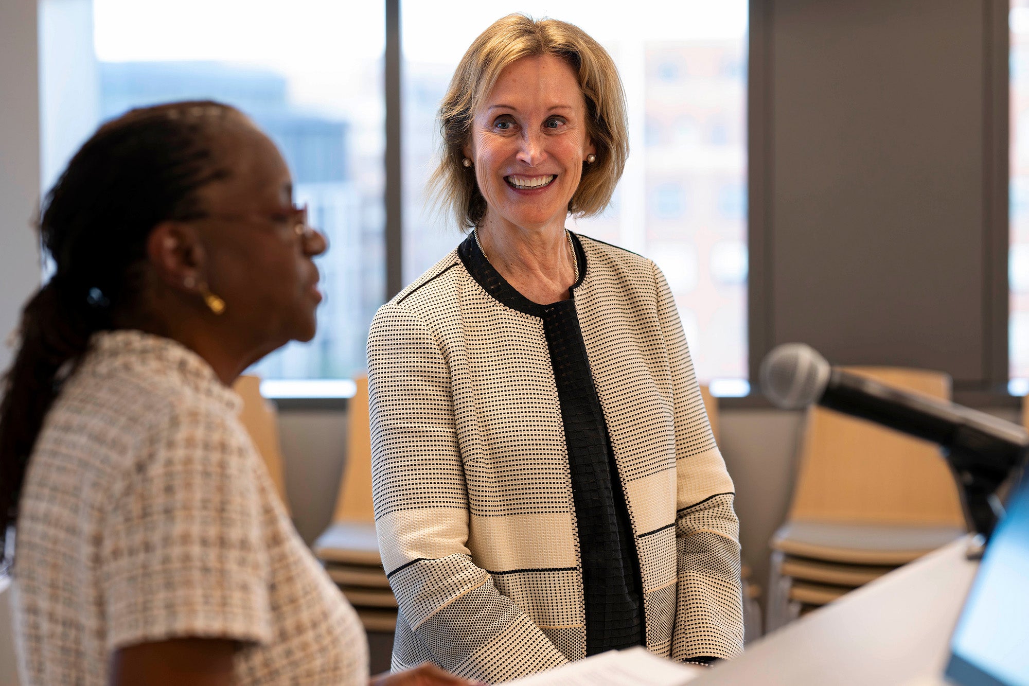 Edilma Yearwood speaks at a podium while Deb Trautman stands next to her