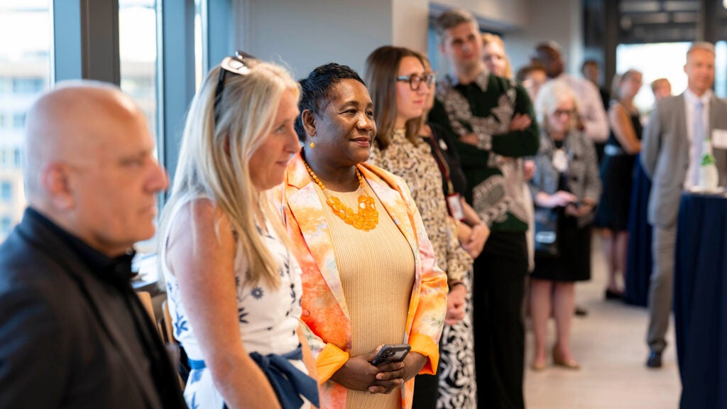 Dean Waite, Carrie Bowman-Dalley and other faculty listen to a speaker at the PhD reception