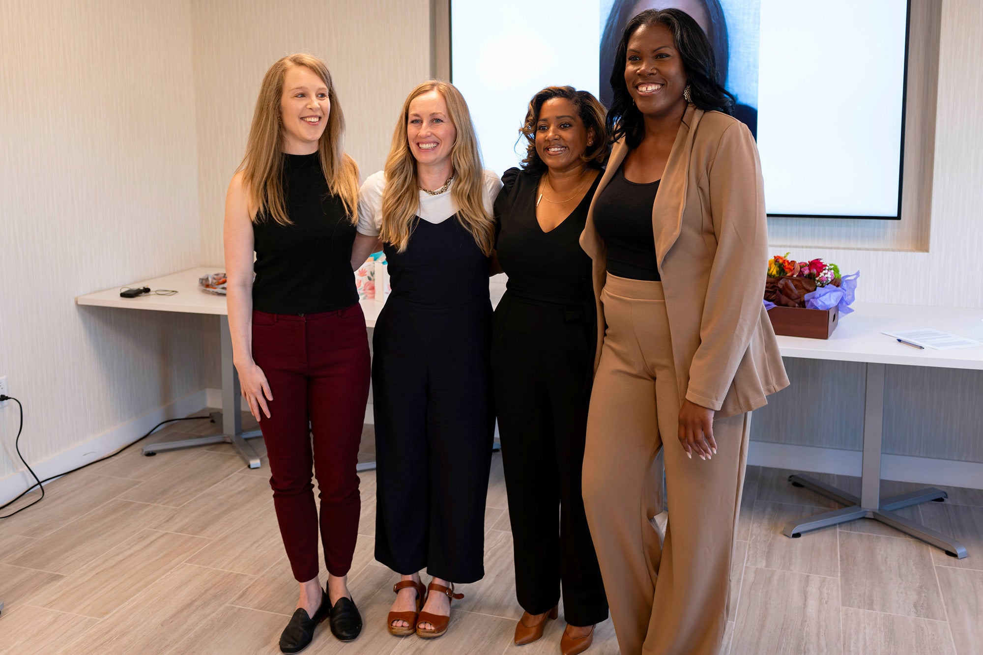 The four PhD students stand together
