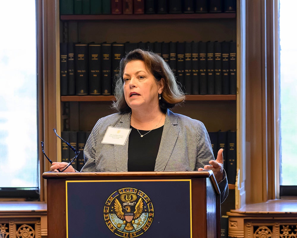LynnMarie Verzino speaks from a podium in Riggs Library