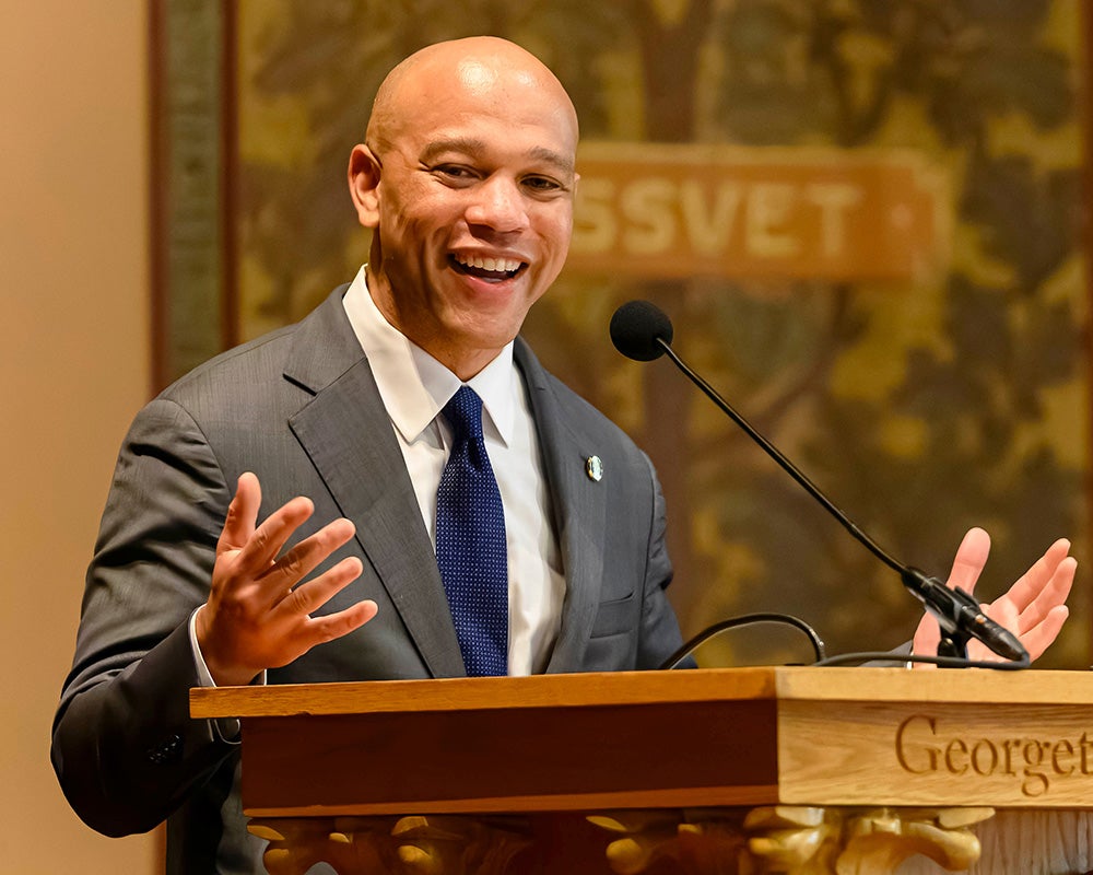 Stephan Davis speaks from a podium in Gaston Hall