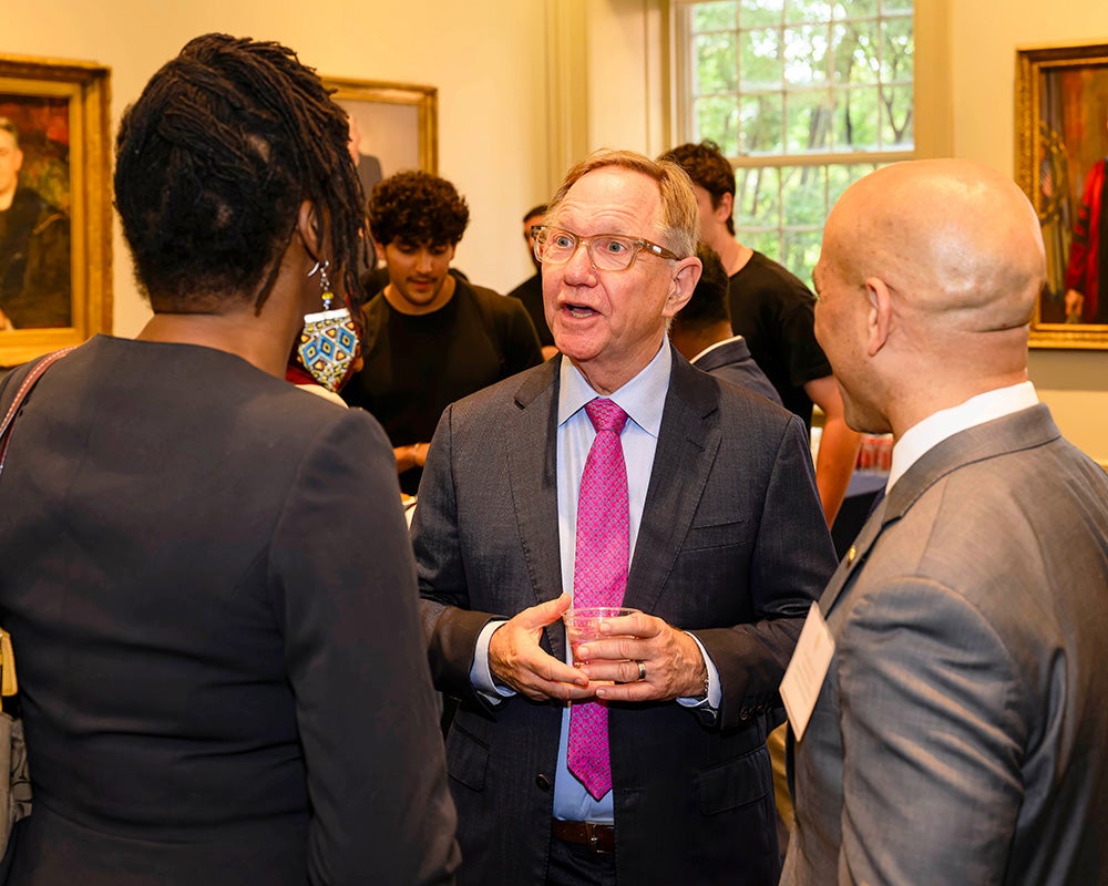 Quint Studer speaks with a woman and  Stephan Davis during the reception