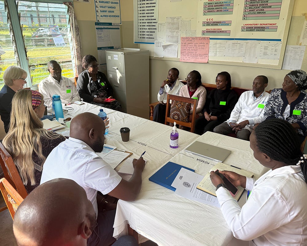 Alex and hospital staff meet with community members