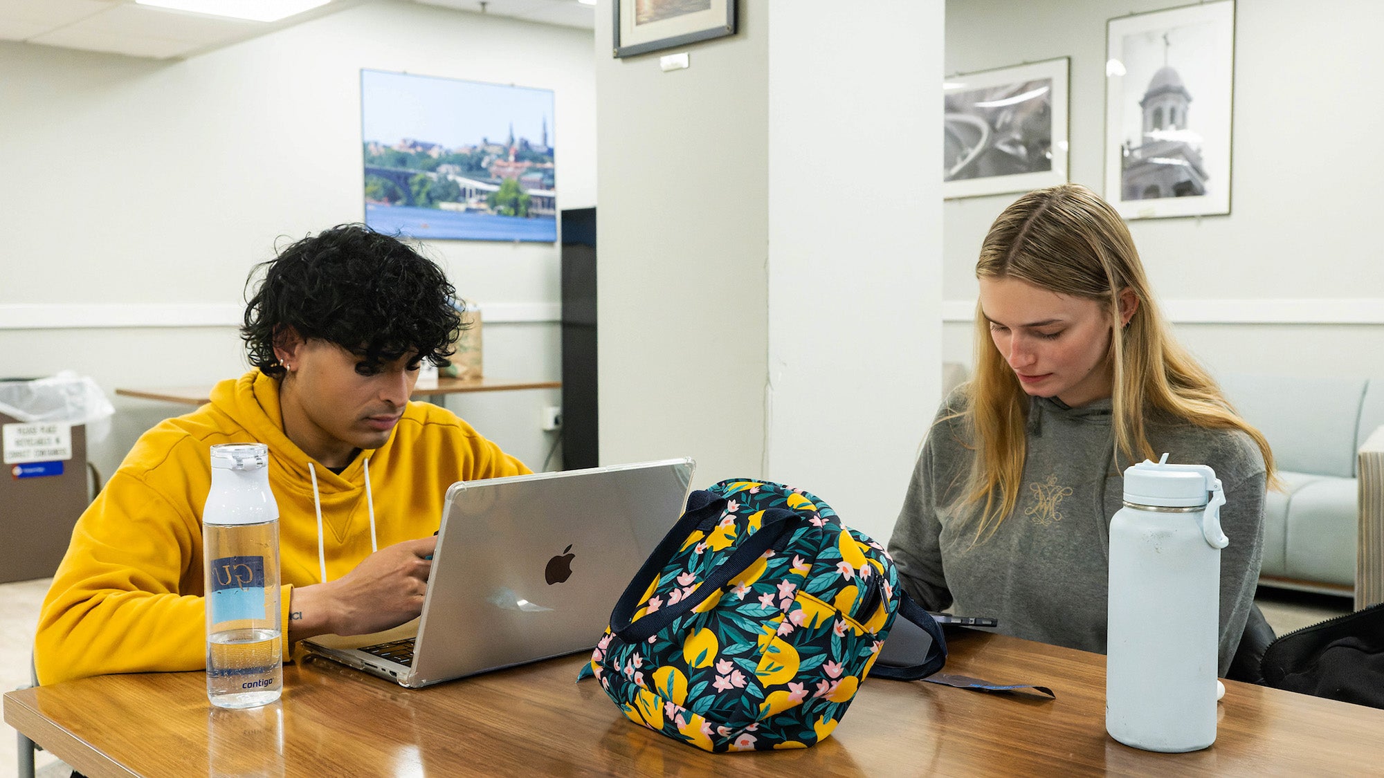 Two students study at a table in Dahlgren Memorial Library