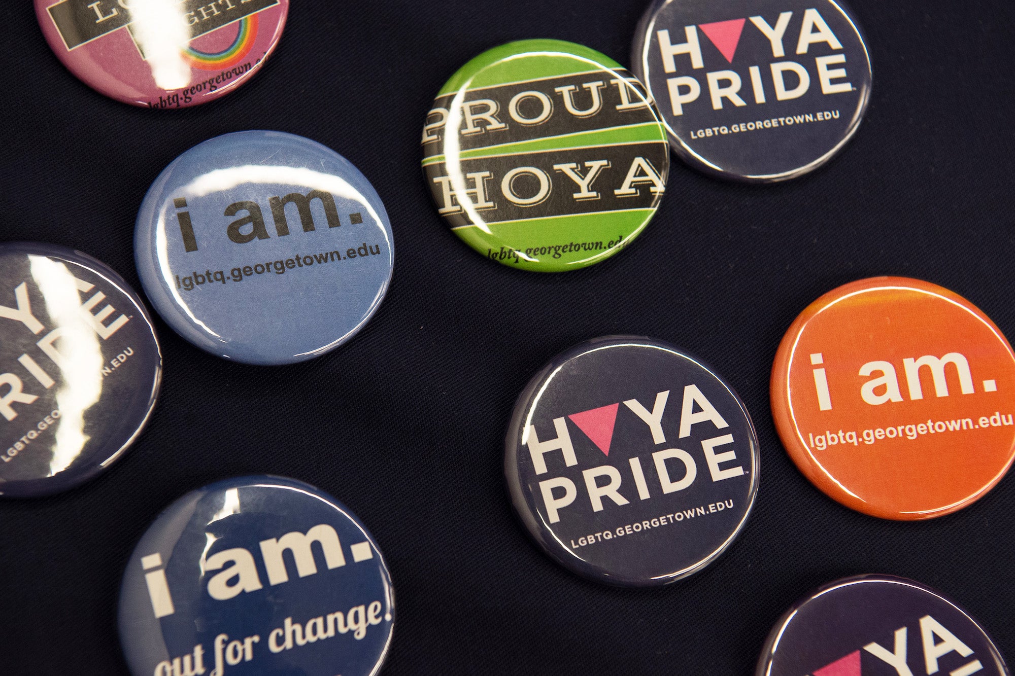 A series of buttons display messages supportive of the LGBTQ community at Georgetown