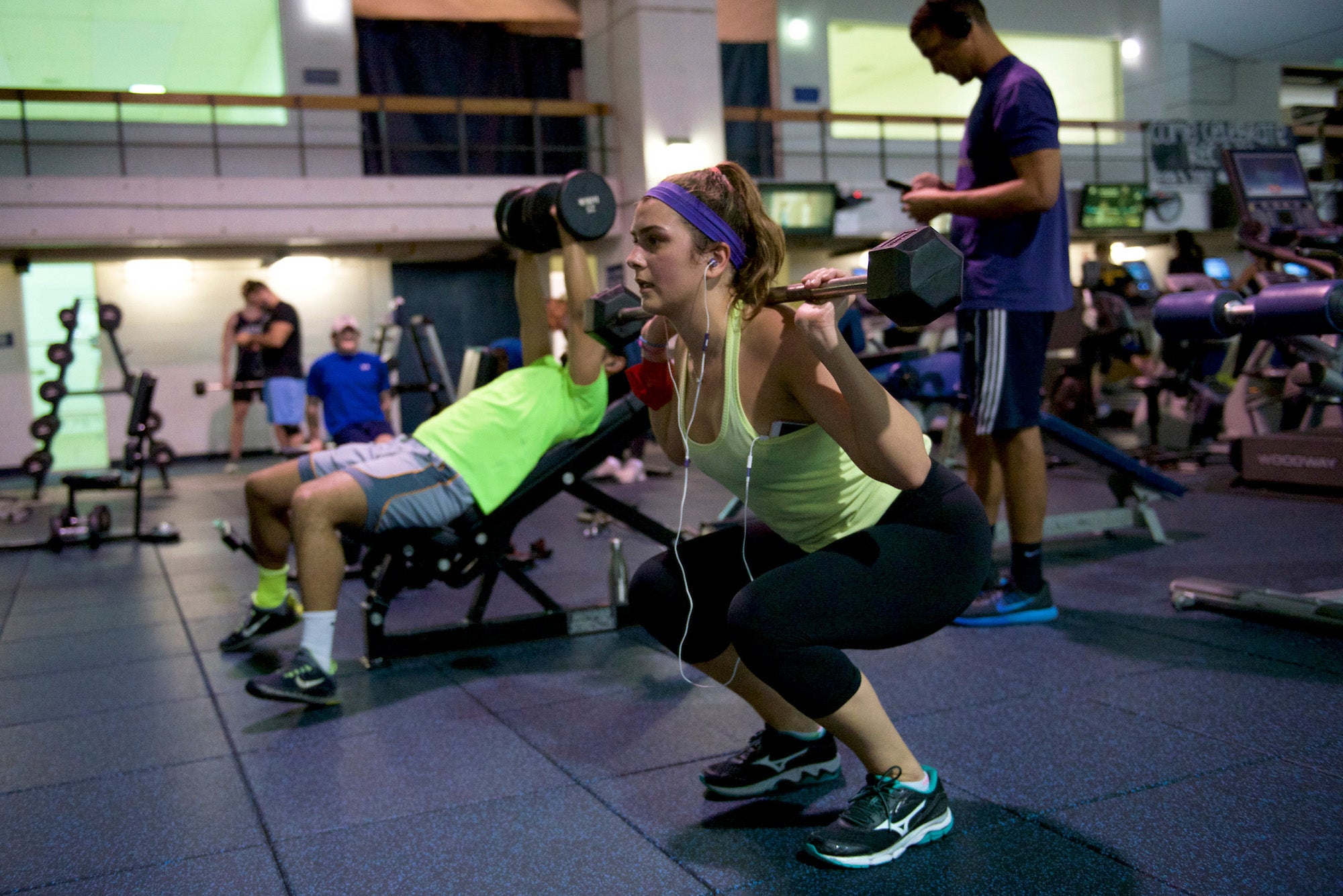 Students work out using weights in Yates Field House on campus
