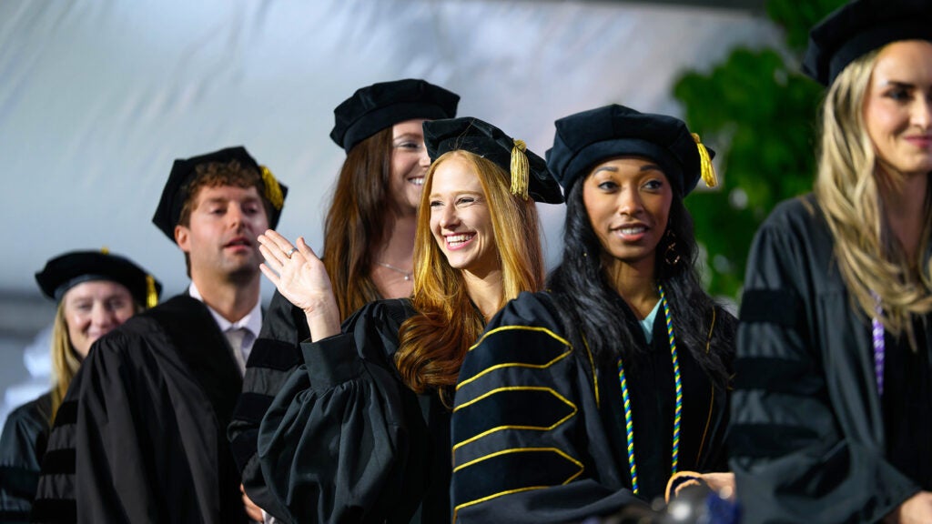 Graduates line up to walk the stage
