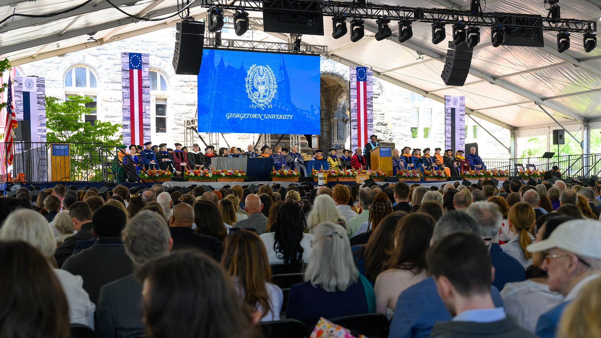 The stage at Commencement viewed from behind the crowd of attendees