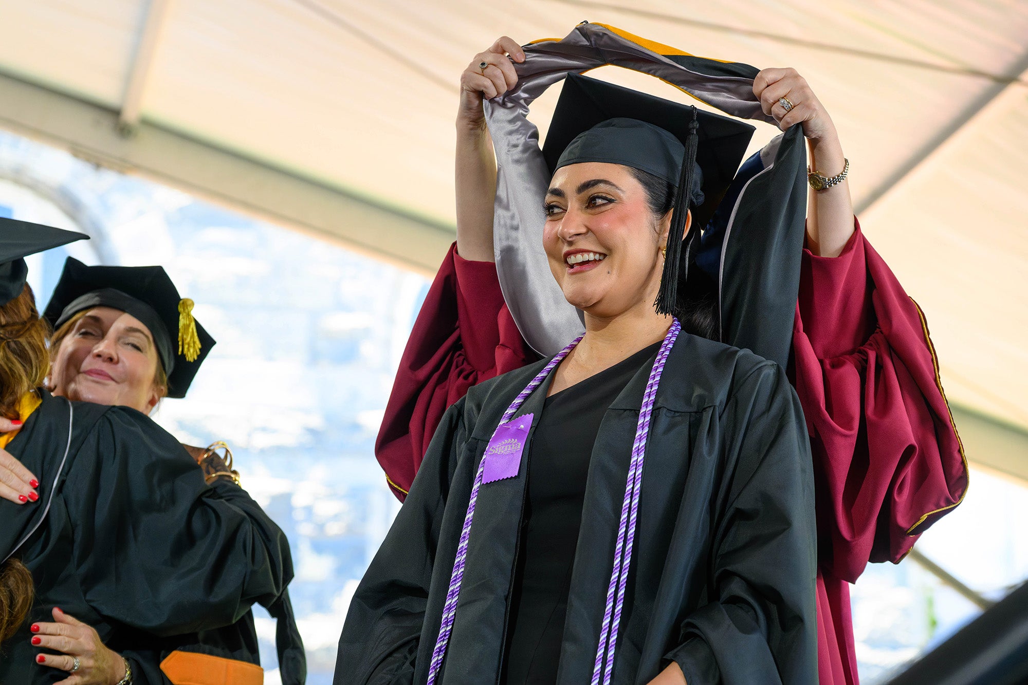 A grad student receives her hood