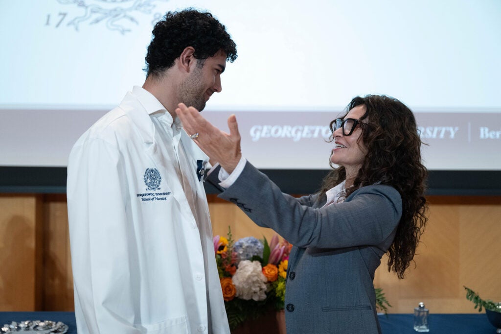 Ladan Eschkevari reaches toward her son, Fenton, with pride
