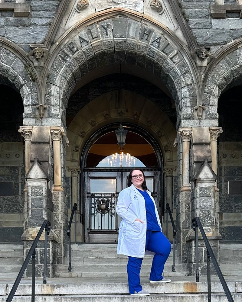 Levy stands on the steps of Healy Hall